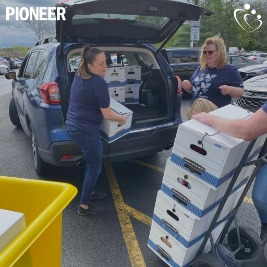 St. Catherine's Food Drive loading car with supplies